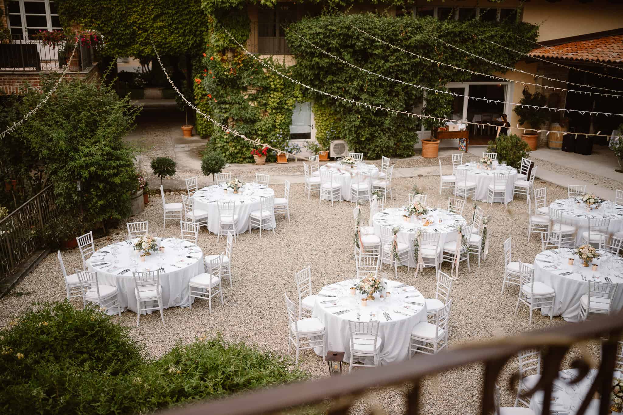 Round white tables for a dinner wedding dinner in Italy.